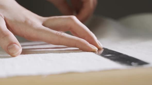The Seamstress Draws with a Ruler on the Fabric with Chalk