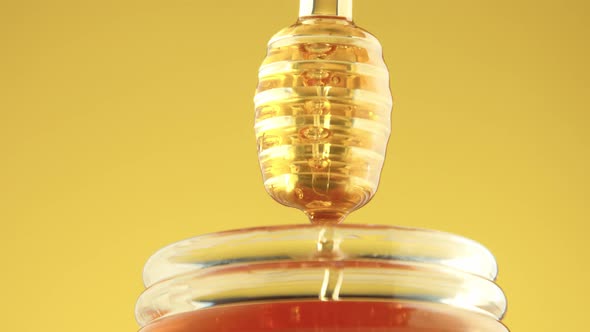 Closeup of Honey Spoon with Pouring Honey