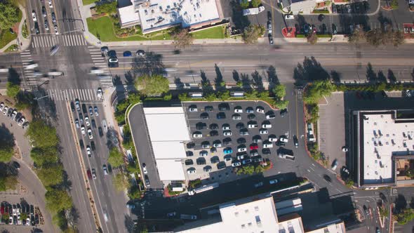 Time Lapse Aerial Fast Driving Vehicles in Line to Refuel at Gas Station in City alt