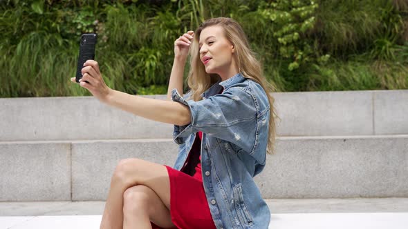 Young Woman Taking Selfie on Street