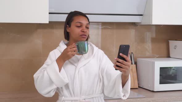 An AfricanAmerican Woman Communicates Online Via Video Link Using a Smartphone