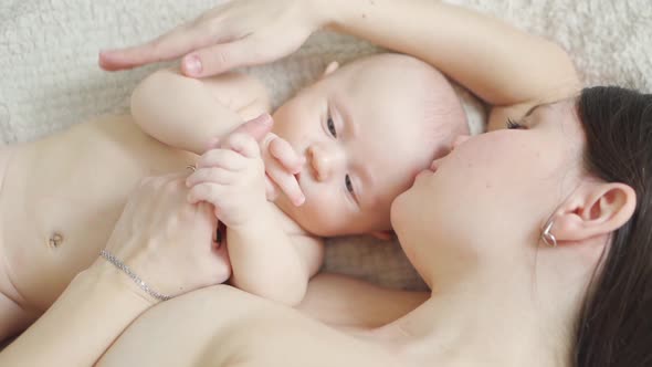 a Naked Mother and the Baby on the Bed, Stock Footage | VideoHive