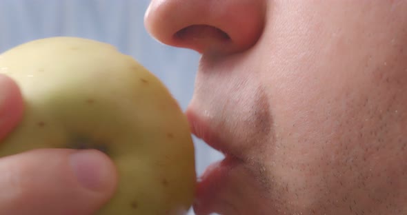 A Person Bites Off an Apple Closeup alt