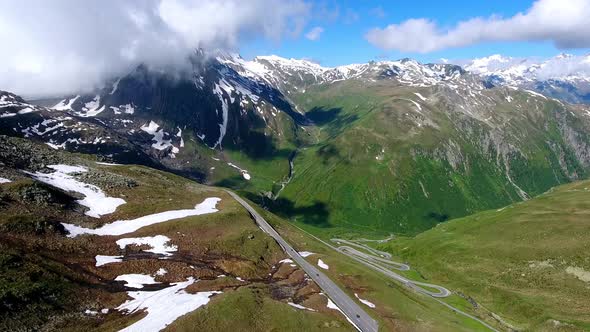 Aerial shot of Nufenenpass Early summer with unmelted patches of snow alt