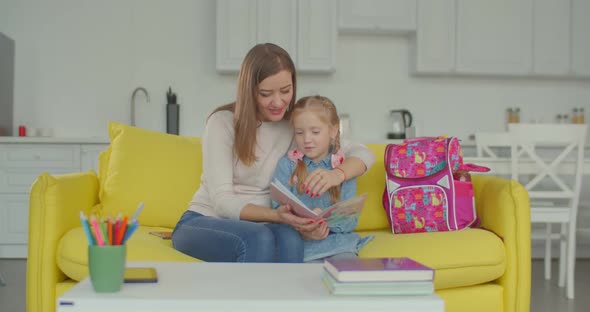 Proud Mom Praising Schoolgirl for Studying Well alt