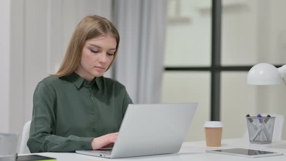 Young Woman Working on Laptop in Office  alt