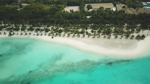 Aerial Drone View of a Beautiful Island with a Resort in the Maldives alt