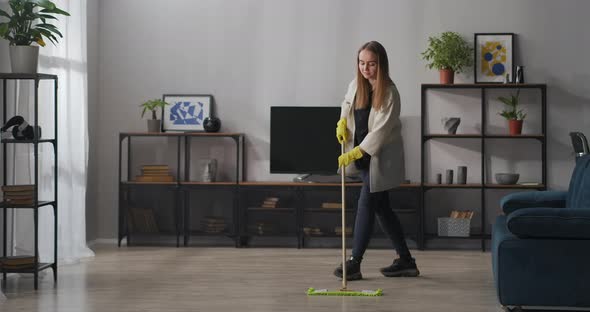 Housekeeping and Cleaning Service Young Woman Is Washing Floor in Room Clean Home at Weekend alt
