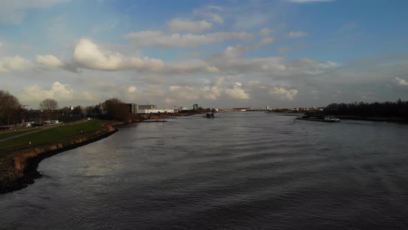 Scenic View With Cargo Vessels Sailing Across Quiet River Of Oude Maas In The City Of Zwijndrecht, N alt
