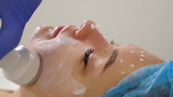 Beauty Clinic and Machine Cosmetology. Professional Cosmetologist Working with Ultrasonic Facial