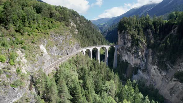 Landwasser Viaduct in Swiss Alps in Summer Aerial View on Green Mountain Valley alt