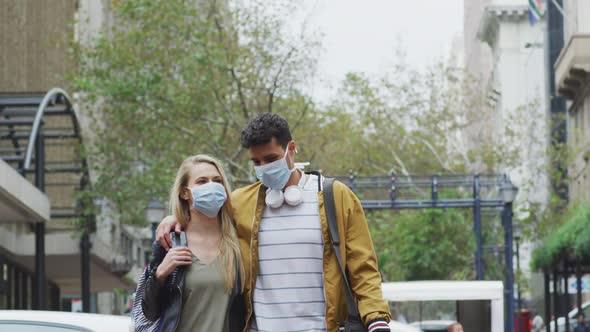 Front view of Caucasian couple on the go wearing mask alt