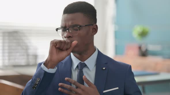 Sick Young African Businessman Coughing alt