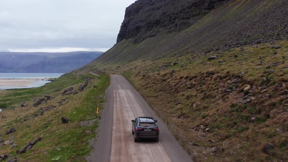 Aerial of Car Driving Along an Empty Rural Road In Iceland alt