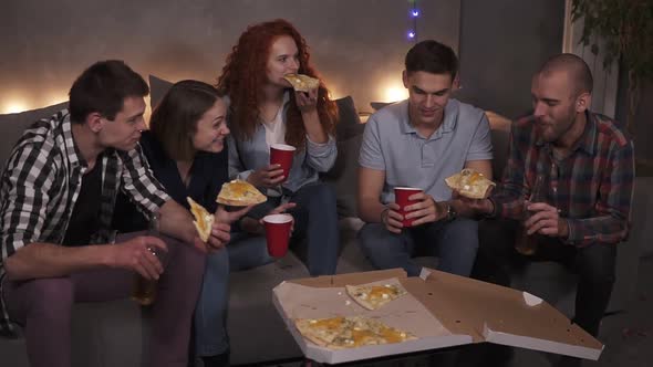 Young People Cheerful Men and Women are Eating Cheesy Pizza Chatting Relaxing During Indoor Party in alt