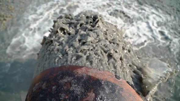 Wastewater from Large Rust Pipe Merge into Environment. Sewage from Sewer Pollutes Terrain alt
