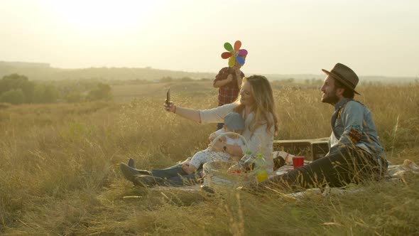 Happy Family Taking Selfie During Morning Picnic