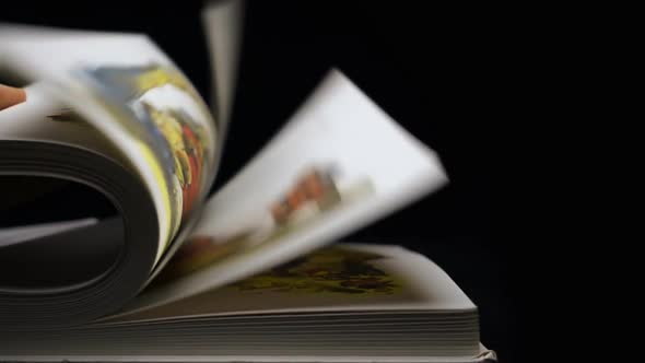 The Hand Turns Over The Pages Of The Book On Black Background 2