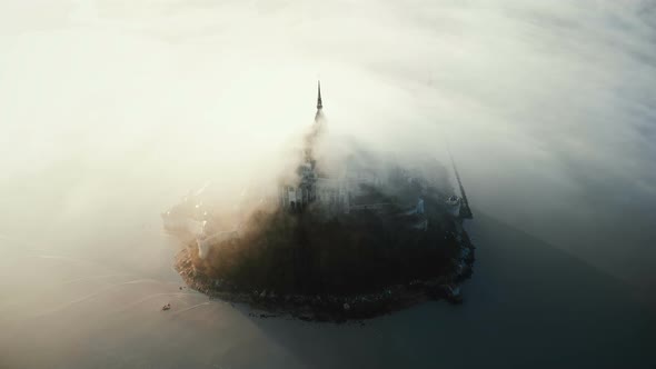 Drone Flying Around Famous Mont Saint Michel, Ancient Island Fortress Castle Hidden By Thick Foggy alt