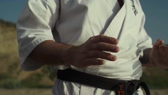 Black Belt Fighter Training Hands Exercises Practicing Karate Ion Beach Closeup alt