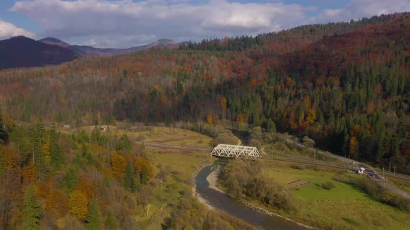 View From the Height on the Autumn Mountain Landscape - Yellow Forest, River, Railway Bridge and alt