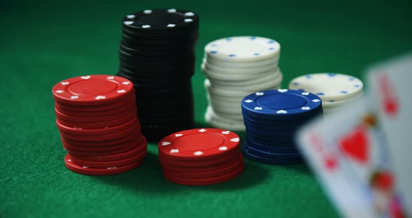 Playing cards and casino chips on poker table 4k alt
