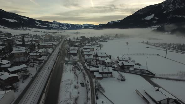 Aerial view of a road and train rails alt