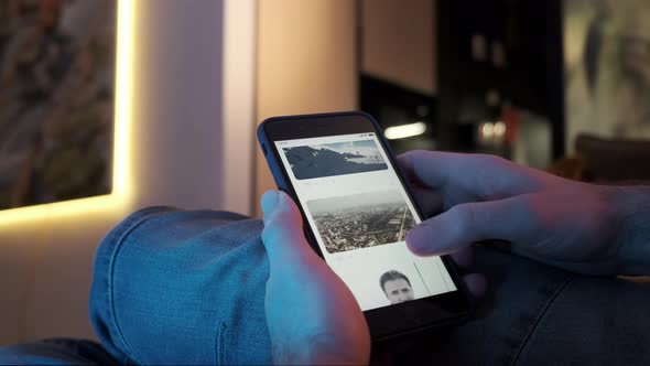 Man Using Smartphone Scrolling Through Social Network Feed Doing Swiping Scrolling Gestures alt