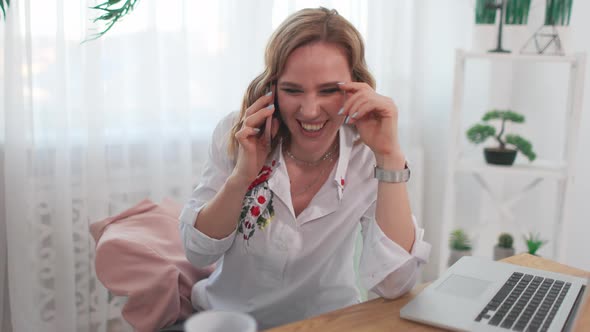 Charming Woman Talking on Cellphone in Office alt