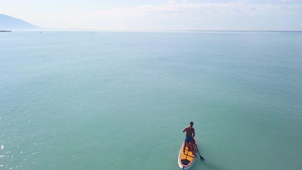 Man practicing stand up paddle or SUP alt