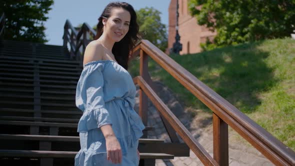 Beautiful Woman in Summer Fashion Dress Walking on Stairs in the Middle of City