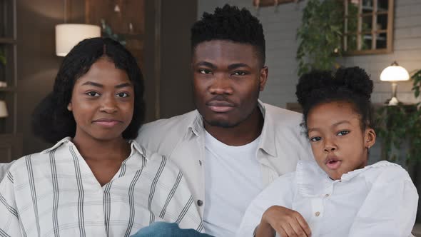 African American Biracial Multiracial Family Parents with Daughter Kid Child Girl Sitting on Sofa at alt