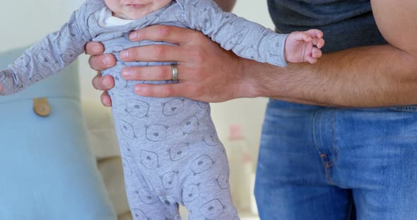 Father holding his baby boy 4k alt