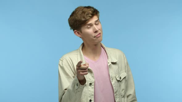Sassy Guy in Casual Clothes Pointing Finger at Camera and Nodding with Respect Praising you Making a alt