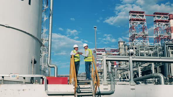 Petroleum Refinery Workers Are Talking About A Project, Stock Footage