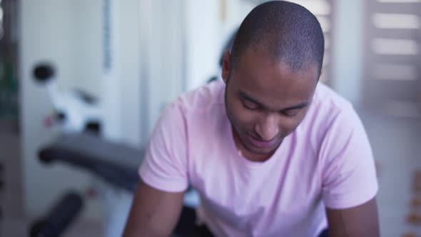 Male Is Talking in the Gym. Portrait of an African American Man in a White T-shirt People in the Gym alt