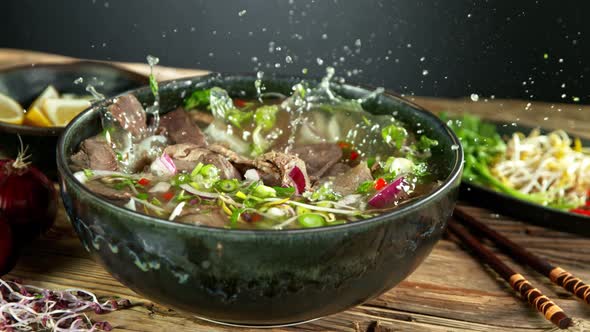 Super Slow Motion Shot of Sliced Beef Falling Into Pho Soup at 1000 Fps alt