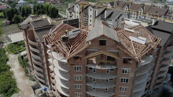 Aerial Construction of a Brick House. Installation of Wooden Roof alt