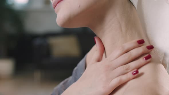 Young Woman Applying Body Lotion On Neck alt
