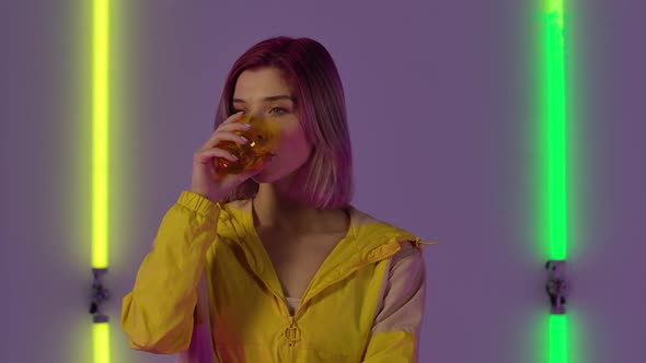 Portrait of Young Stylish Woman Drinks Water From Glass Then Spits It Out with Wow Surprised and alt