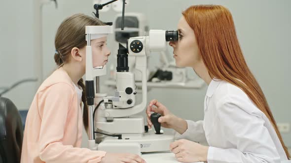 Optometrist Checking Vision of Little Patient alt
