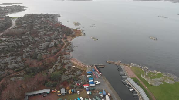 Rocky Shoreline and Winterized Boats at Small Marina Aerial Reveal