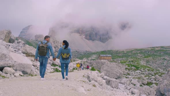 Couple Hiking in the Italian Dolomites During Foggy Weather with Clouds Stunning View to Tre Cime alt