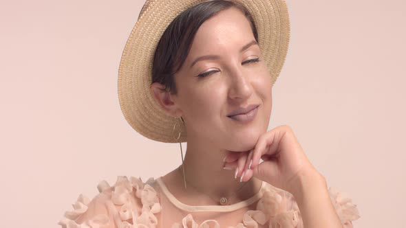 a Young Moroccan Woman Wears a Hat in the Studio and Monochrome Makeup