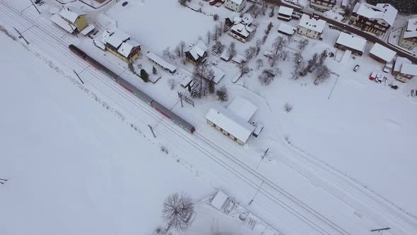 Aerial view of a train rolling during winter alt