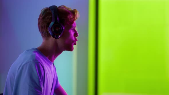 Excited Player Losing Game in Neon Room Closeup alt