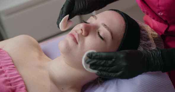 Cosmetologist Cleans a Woman's Face with Sponges Face Care at the Beauty Salon  60p Prores HQ alt