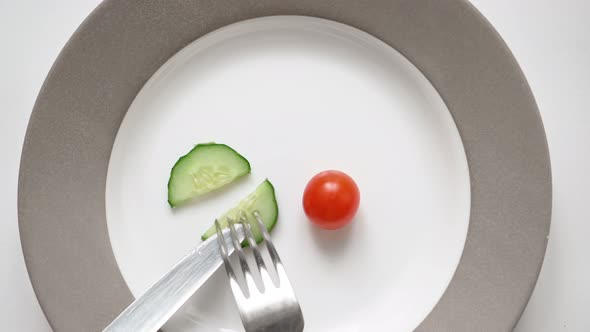Man on Diet Eats Very Little Chili Tomato and Cucumber Plate alt
