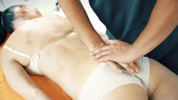 Crop Osteopath Hands Massaging Back of Female Patient