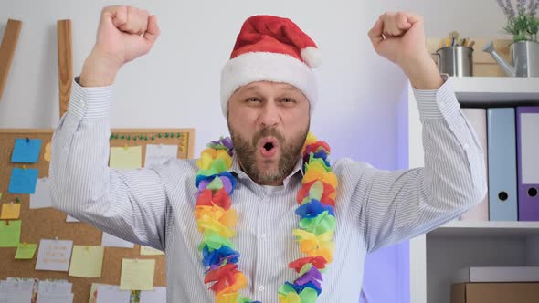 Middle aged man in a Santa hat smile at the camera. Christmas Videocall concept.